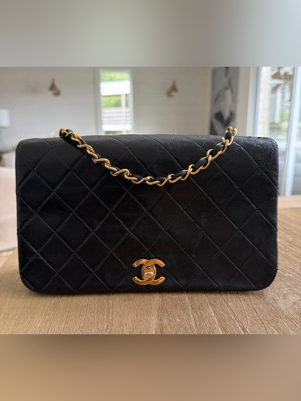 CHANEL Black Quilted Shoulder Bag with Gold Chain and CC Lock